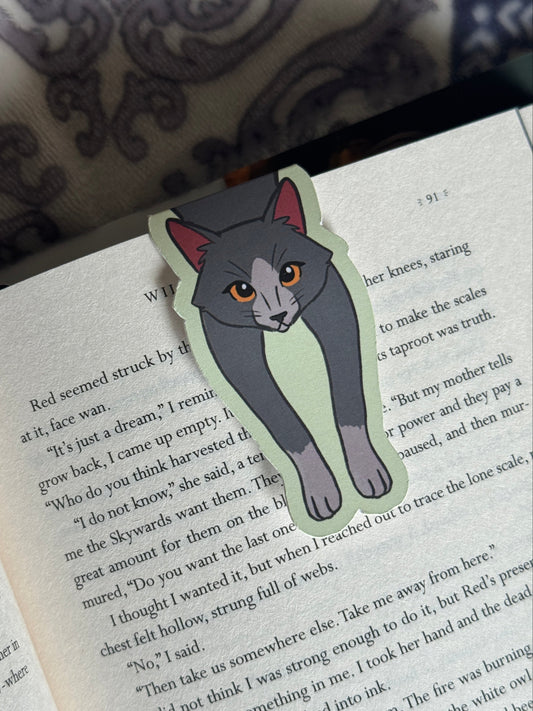 Cat-shaped bookmark on a book page
