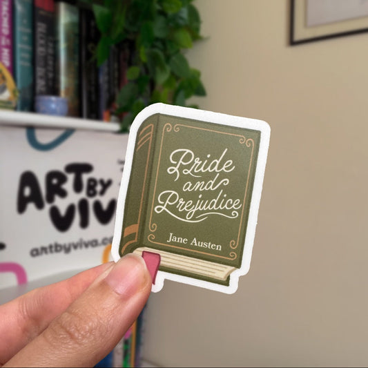 Sticker of 'Pride and Prejudice' by Jane Austen held by a hand with a bookshelf in the background.